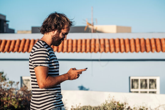 Man texting on smartphone outdoors connecting online