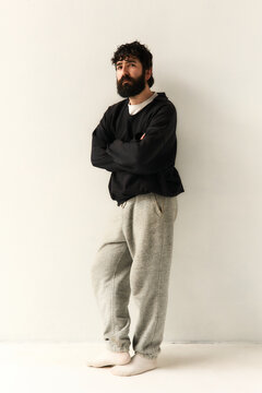 Bearded man standing in minimal interior
