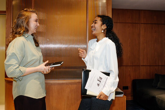 Two Businesswomen Discussing in Modern Office