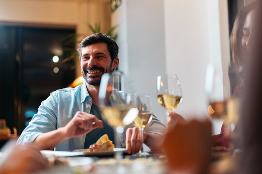 Friends having dinner and laughing at restaurant