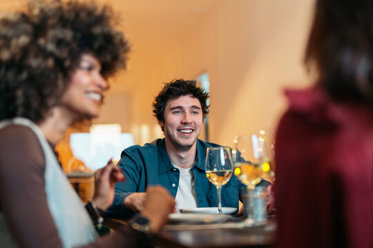 Friends enjoying dinner and drinks in restaurant