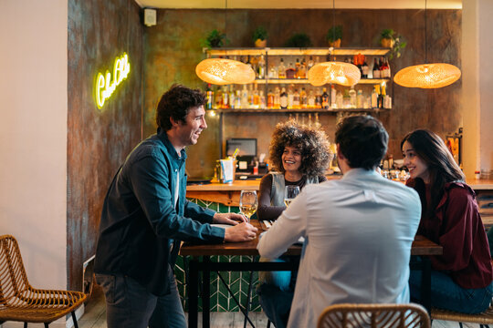 Friends enjoying dinner and drinks at a restaurant