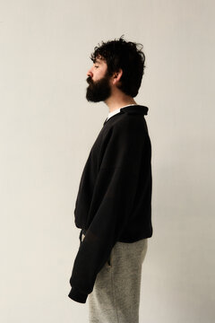 Bearded man standing in minimal interior
