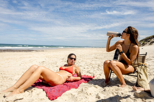 UGC Two women relaxing together on beach in Bundjalung National Park