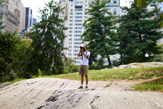 Man takes photos in central park, NYC.
