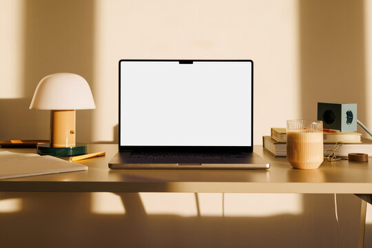 Business laptop mockup on home office desk with coffee