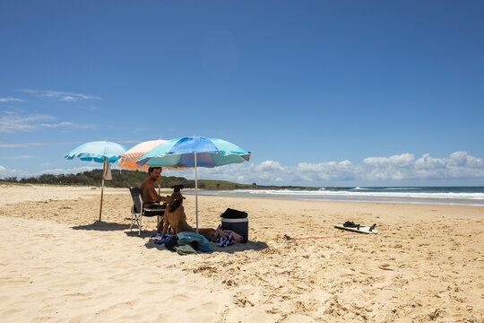 Friends enjoying beach day in summer in Yamba Australia