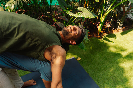 Group Yoga Practice in a Garden During Sunny Day
