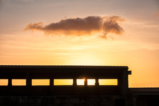 Stone structure silhouette framing sunset sky in Galicia