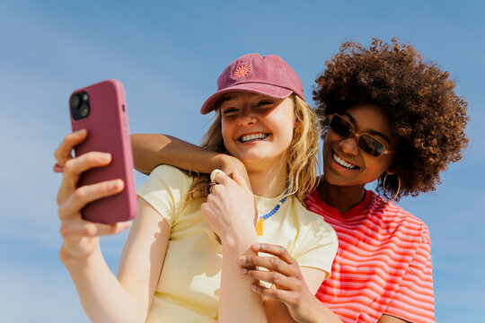Friends taking selfie outside capturing happy memories