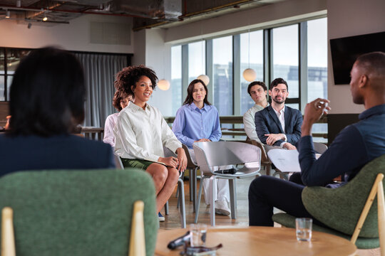 Diverse group of professionals in a modern meeting space.
