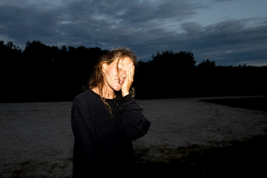 UGC Woman covering face and smiling at campsite in Australia 