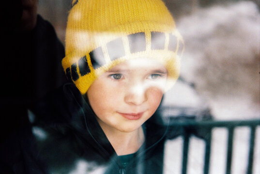 Portrait of Child Looking outside at Fresh Snow