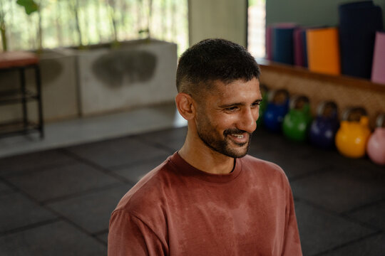 Trainer Smiles During Yoga Session in the Fitness Centre