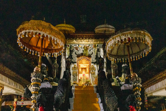 Temple shrine illuminated during nighttime ceremony in Bali