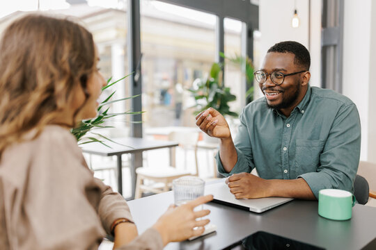 Two People Talking in a Cafe During Daylight Hours