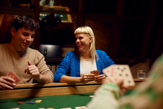 Friends gather for poker at night.