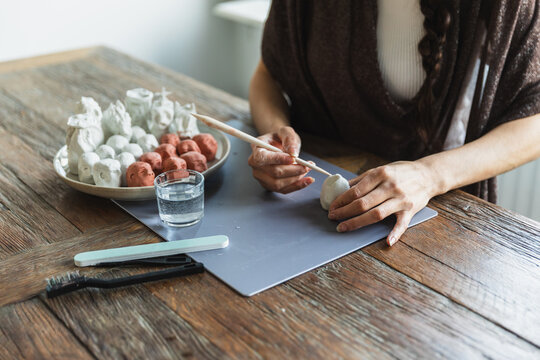 Close-up of artist's hands sculpting small clay figures