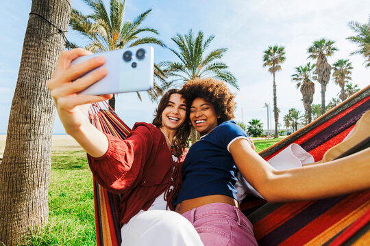 Diverse friends taking selfie on beach vacation