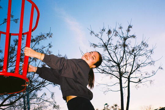 Woman on playground spinner