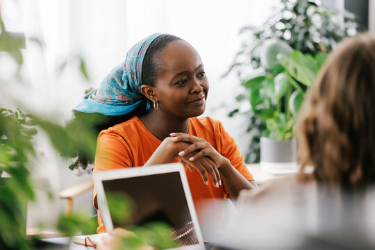 Young black woman at a business meeting talking with colleagues 