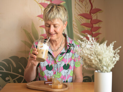 Woman Enjoying Iced Coffee Drink in a Cafe