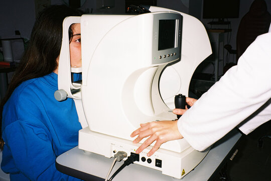 Girl eye exam with optometrist