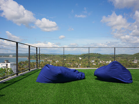 Rooftop Seating Area With Blue Bean Bags and Scenic View
