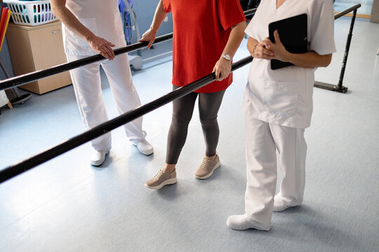 Physiotherapy team assisting patient with walking exercise