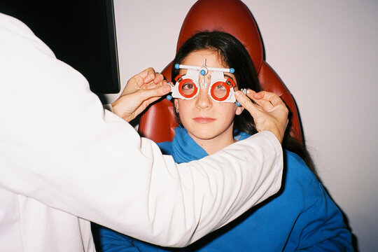 Optometrist adjusting trial frame