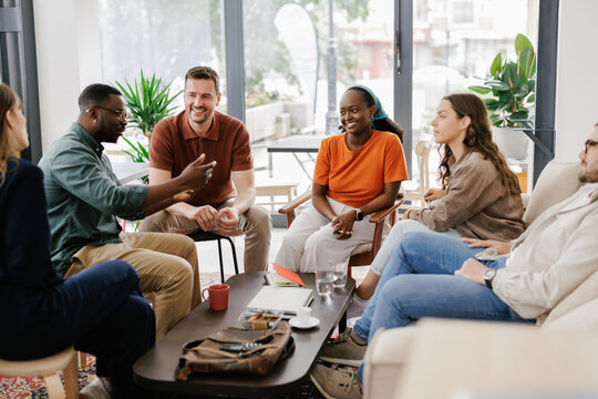 Friends Gather for Discussion at a Modern Cafe in the Afternoon