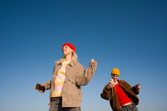 People Listening Music And Dancing In Blue Sky