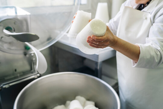 Cheesemaker crafting traditional ricotta cheese in dairy factory
