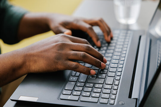 Hands Typing on Laptop in an Indoor Setting During Daytime