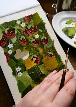 A woman's hand next to her illustration