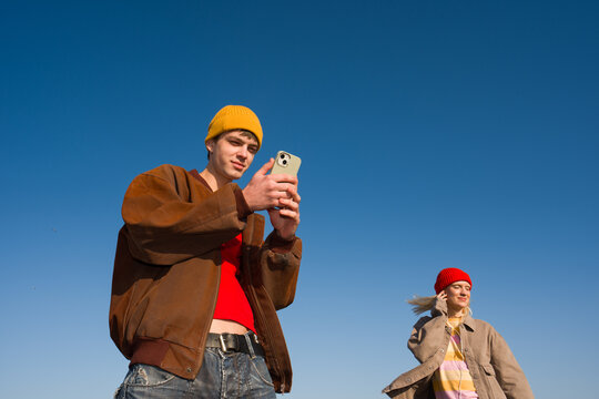 Young People Listening Music, Using Phone And Dancing On A Rooftop