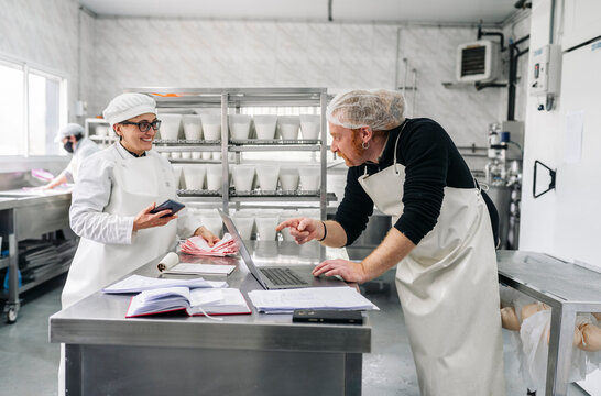 Artisan cheesemakers couple managing small business using technology