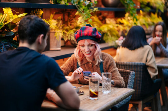 Friends enjoying drinks and conversation at bar restaurant