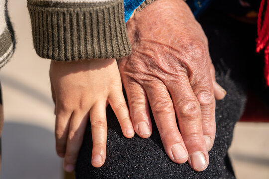 Hands of grandchild and grandparent