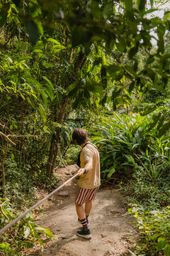 Person walking along a dirt path in a forest 