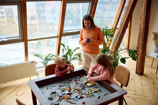 Woman spends time with her children playing