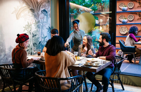 Diverse group enjoying dinner at an upscale restaurant