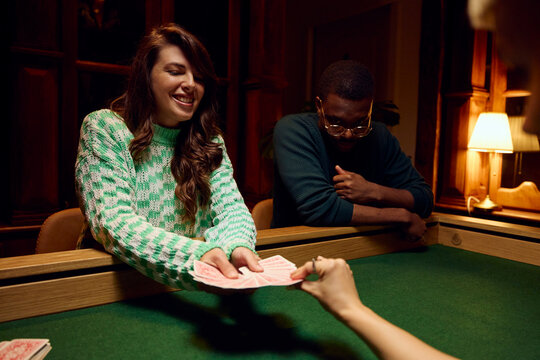 Woman is holding a deck of cards