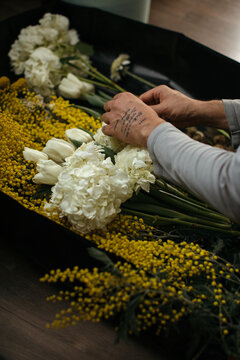 Crop man hands choosing flowers