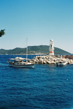 Film Photo of Sailboat Passing Lighthouse on Turkish Aegean Coast