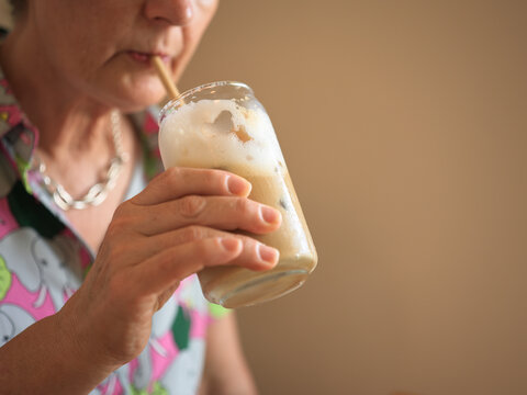 Enjoying a Cold Drink While Sitting Indoors in the Afternoon