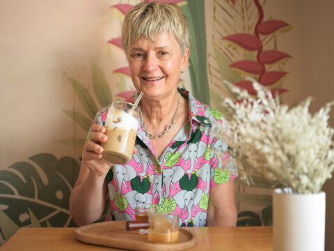 Woman Enjoying Iced Coffee Drink in Cafe