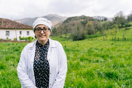 Artisan cheesemaker woman smiling in rural village