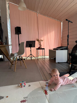 Baby crawls on the mat in indoor space
