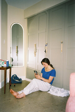 Teen  film  mobile phone  in bedroom at Home film alone